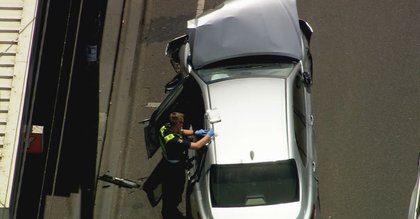 Man restrained by passersby after car crashes into multiple others on busy road