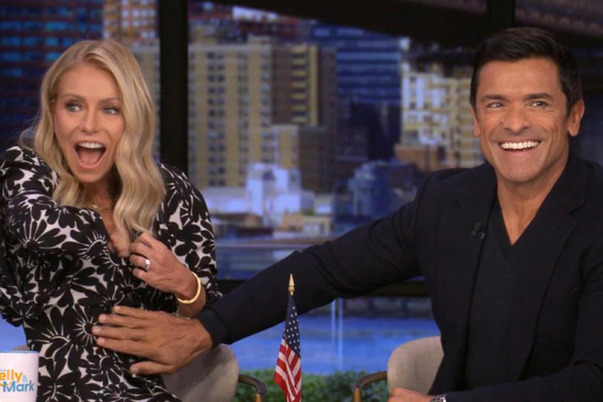 Kelly Ripa Has to “Reach Deep Down Into the Cleavage” on ‘Live’ After Her Mic Falls Down Her Dress, Prompting Mark Consuelos To Ask: “Can I Find It?”