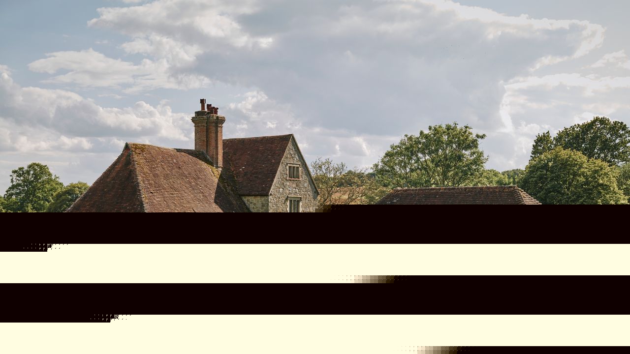 A 17th-century farmhouse in Sussex brimming with antique furniture and vintage textiles that lend it a wonderfully lived-in feel
