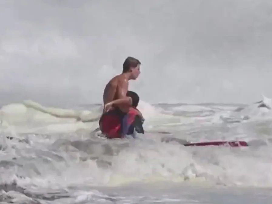 Dramatic video shows teen lifeguard rescuing child from relentless surf