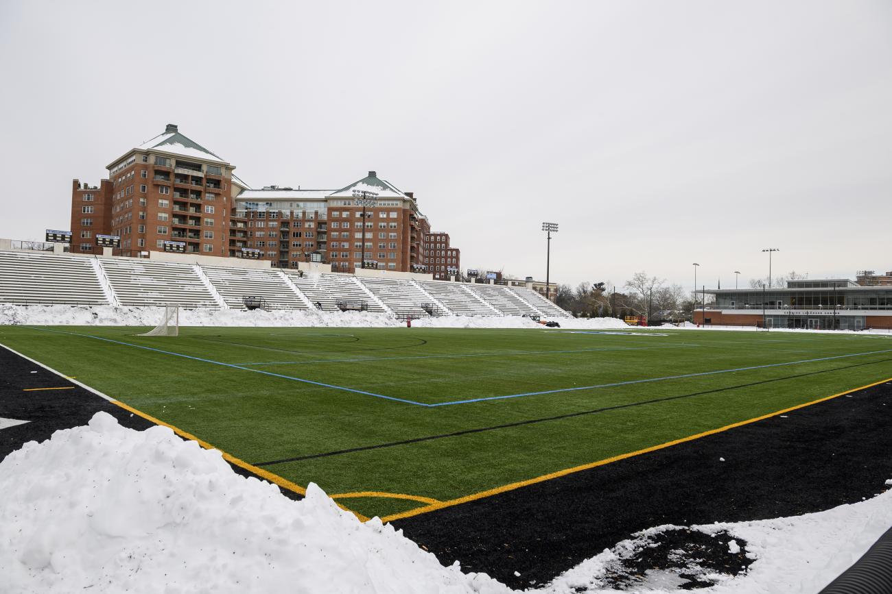Staff dig in to clear Homewood Field for men's lax opener