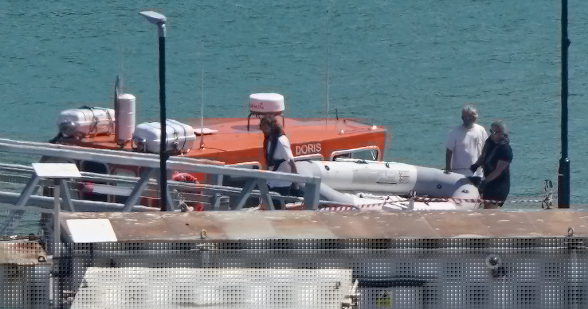 Migrants arrive after rowing tiny dinghy across the Channel