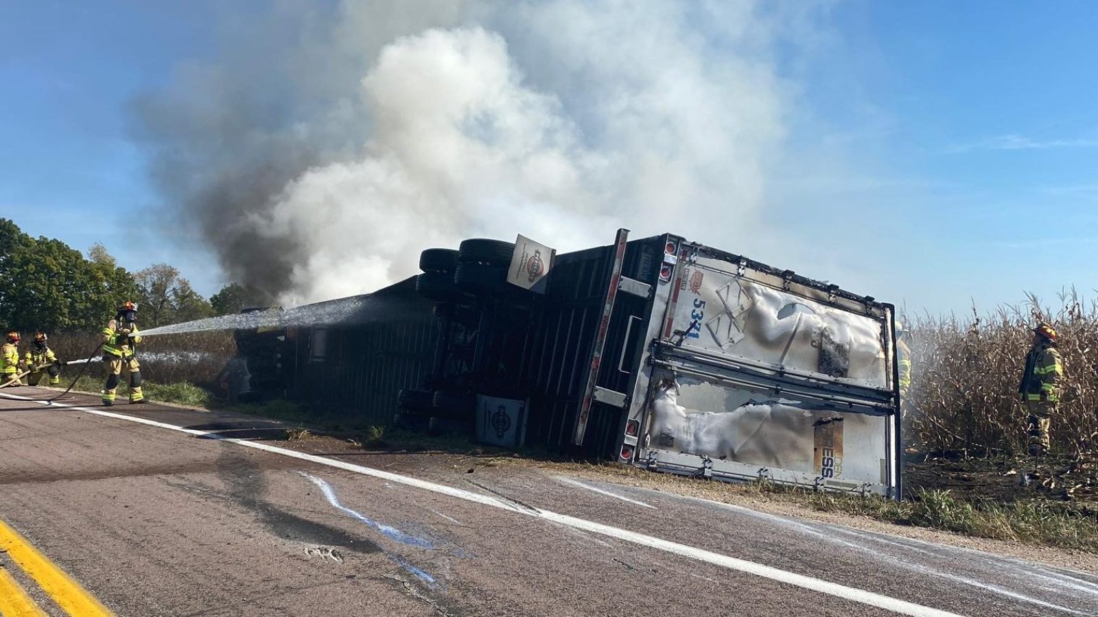 Semi-truck in Wisconsin catches fire & rolls over on curved road, officials close off highway