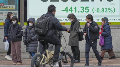Asian shares slip after a wild day on Wall Street