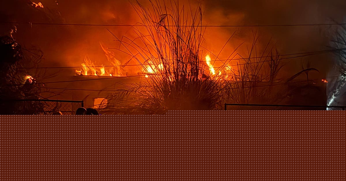 Wind-driven fire burns structures and power poles in Phoenix
