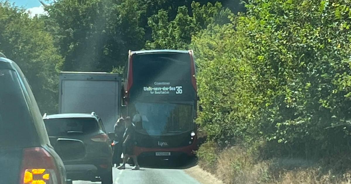 Road closed after double-decker bus and lorry 'wedged together'