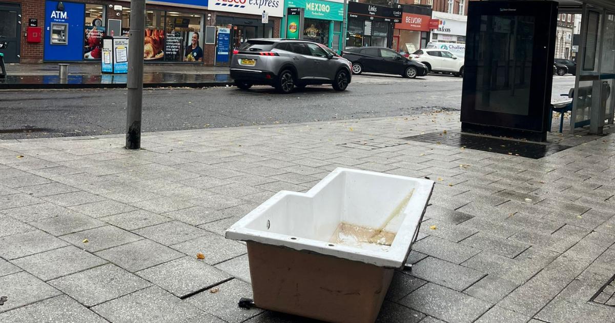 Bathtub dumped on side of busy city road
