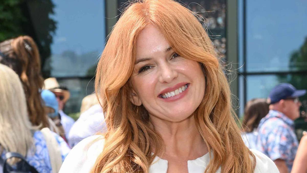 Isla Fisher, 50, showcases stunning physique in plunging black swimsuit