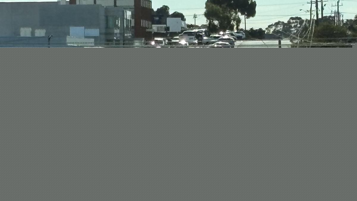 Police officers close Scarborough Beach Road between Hutton Street and Drake Street amid serious crash