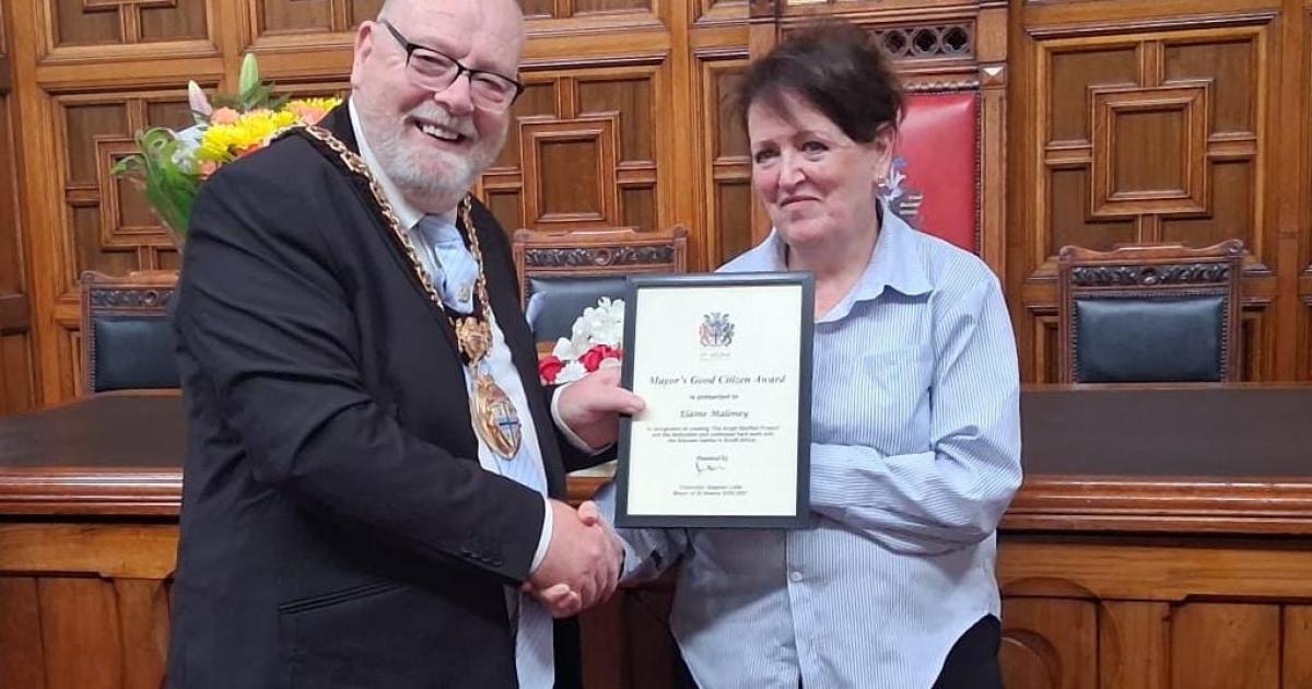 Former headteacher honoured for founding charity that helps children