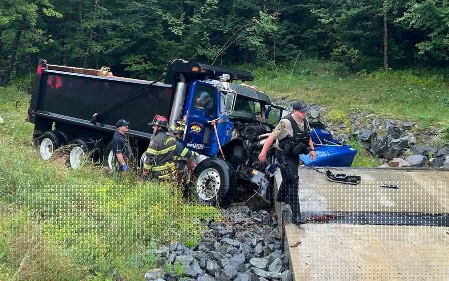 Maine dump truck crashes into concrete culvert while passing a tractor-trailer