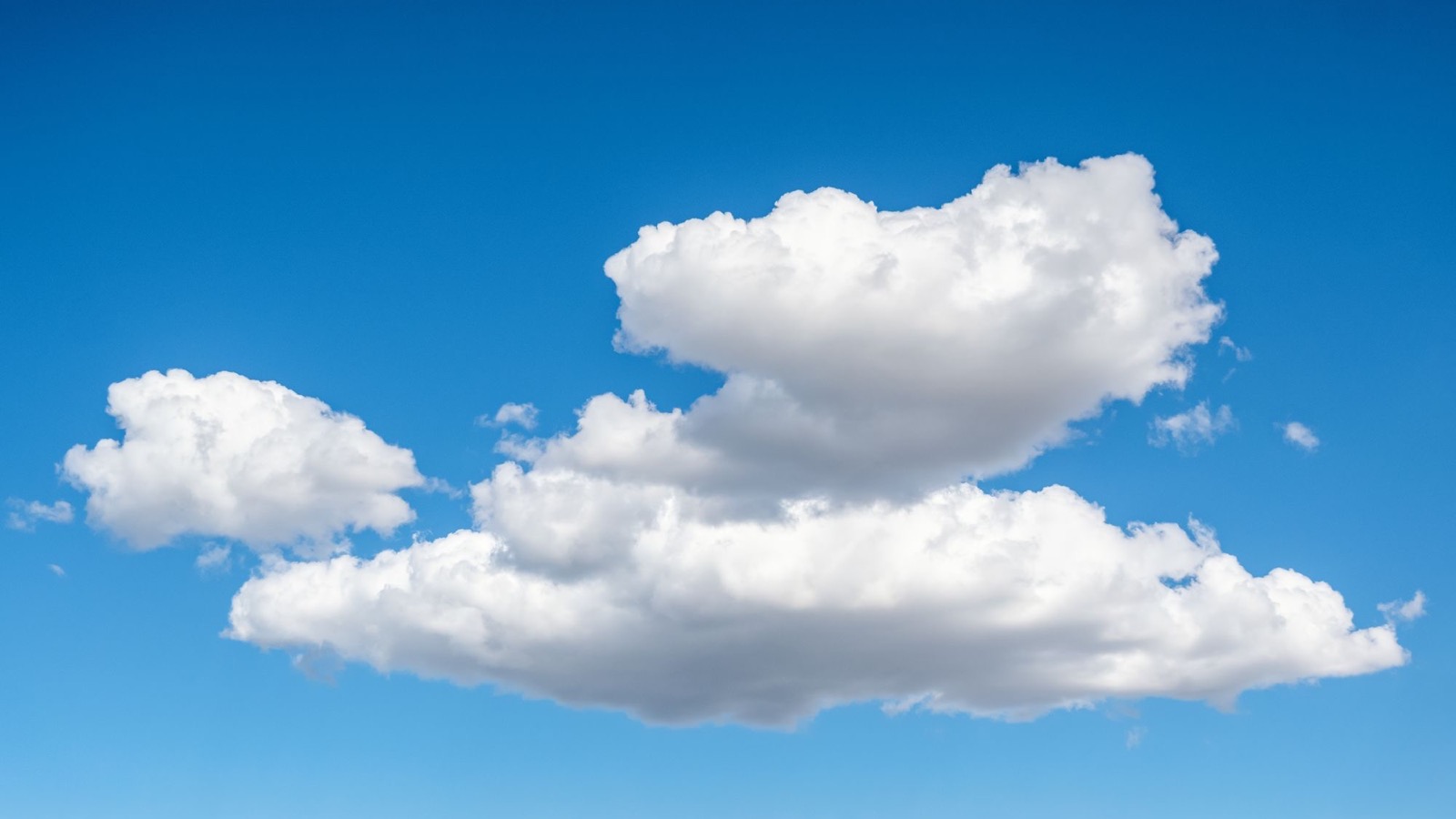 The fluffy white cumulus cloud drifting over your house right now weighs roughly 500 tonnes, the equivalent of 100 elephants, yet it floats because the dry air beneath it is denser than the cloud itself