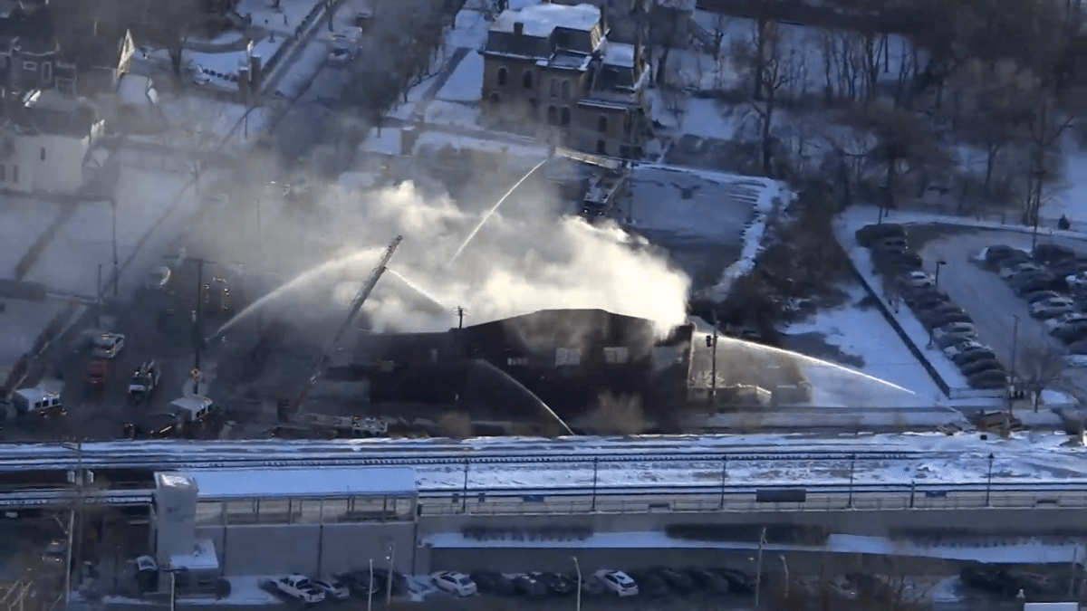 Street blocked as crews fight blaze that partially collapsed suburban building