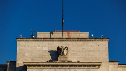 Fed cuts key interest rate, signals two more this year