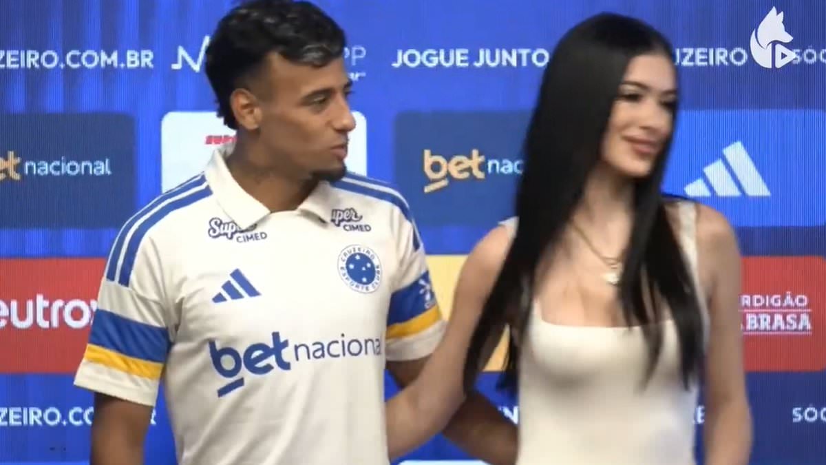 Awkward moment footballer is blanked by his girlfriend dubbed 'Uruguay's Kim Kardashian' after swooping in for a kiss at his transfer unveiling... before hilariously trying to style it out