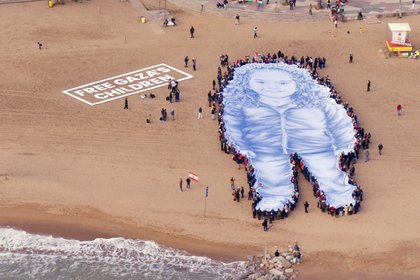 Huge portrait of girl killed in Gaza war unfurled on beach in Spain