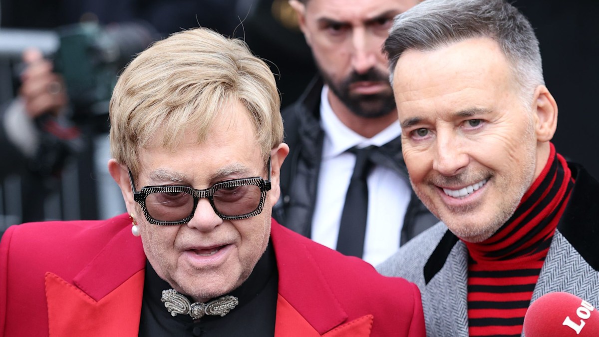 Elton John clutches 'custom' £1.4k Valentino man bag as he's supported by David Furnish in Paris