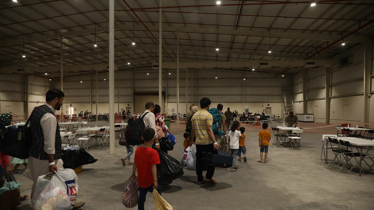 As Airstrikes Loom, Hundreds of Afghan Refugees Still Stranded at U.S. Base in Qatar