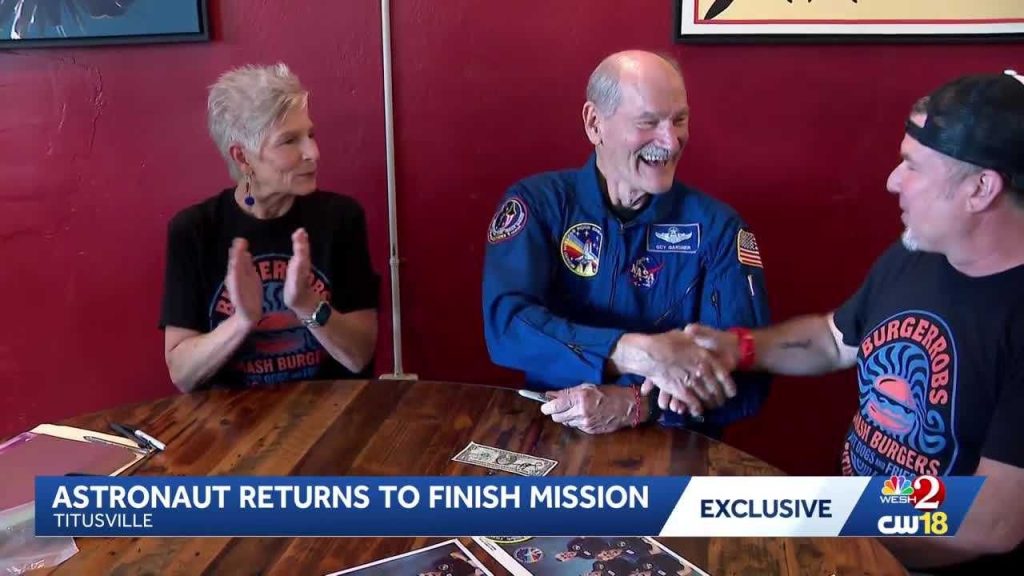 Space Shuttle astronaut adds missing signature to dollar bill signed by fellow crew in Florida