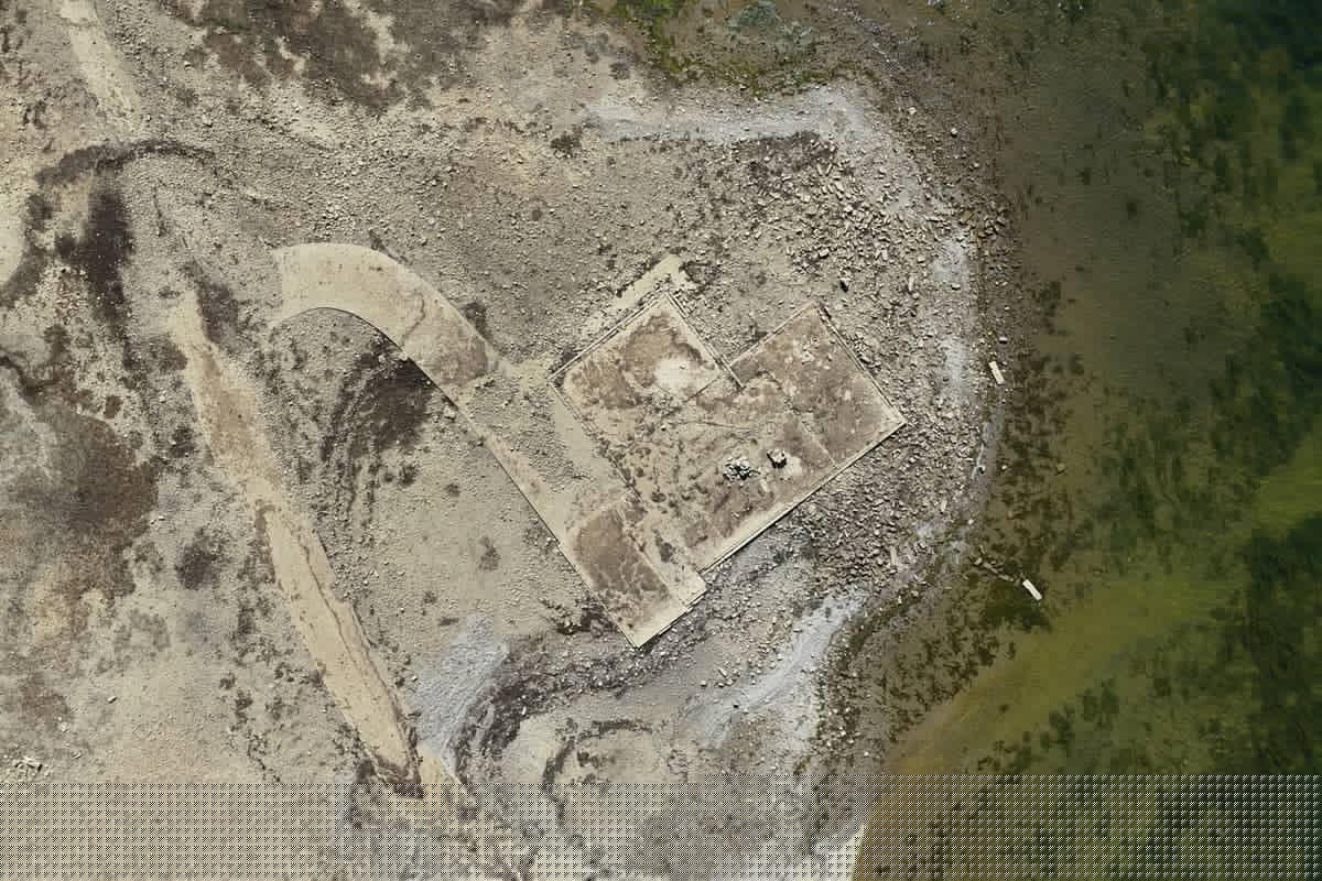 Remains of lost village uncovered as drought lowers reservoir levels in record-breaking heatwave
