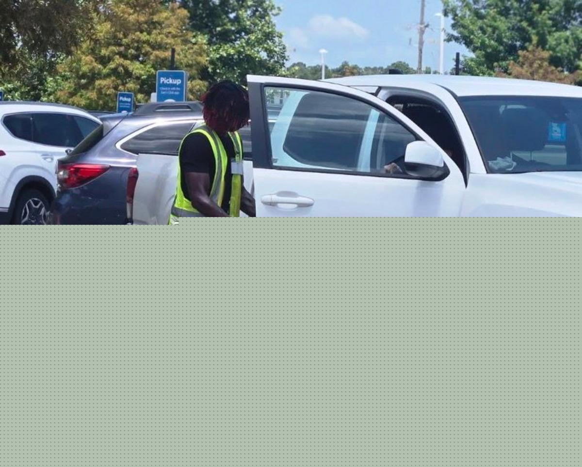 See The Viral Photos of Young Louisiana Man Assisting an Elderly Woman
