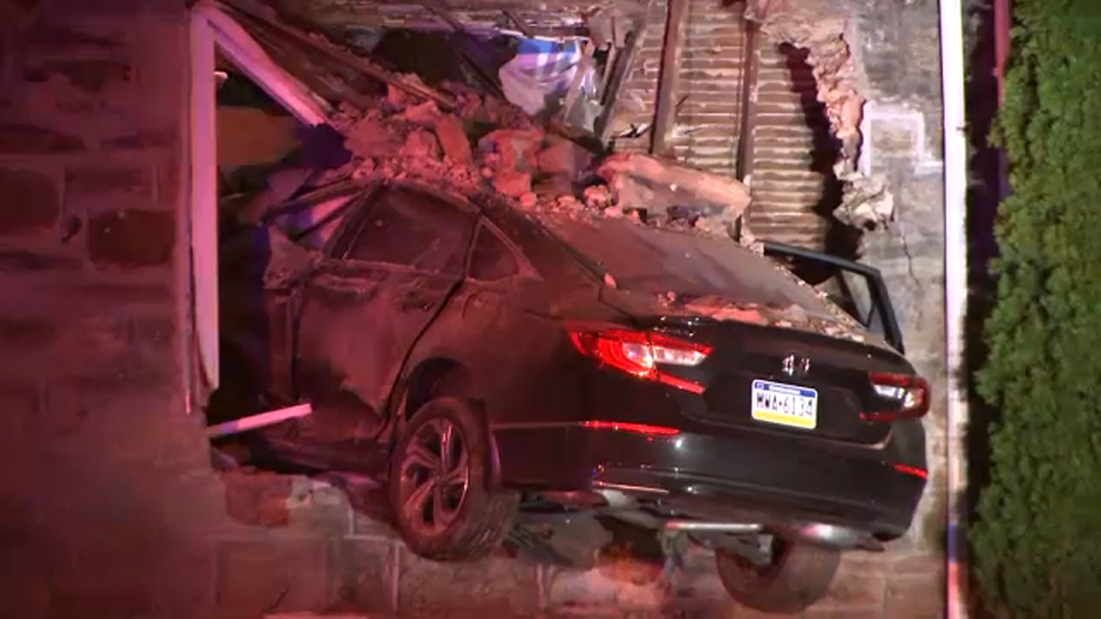 Car goes airborne after crash, smashes through window of Frankford home
