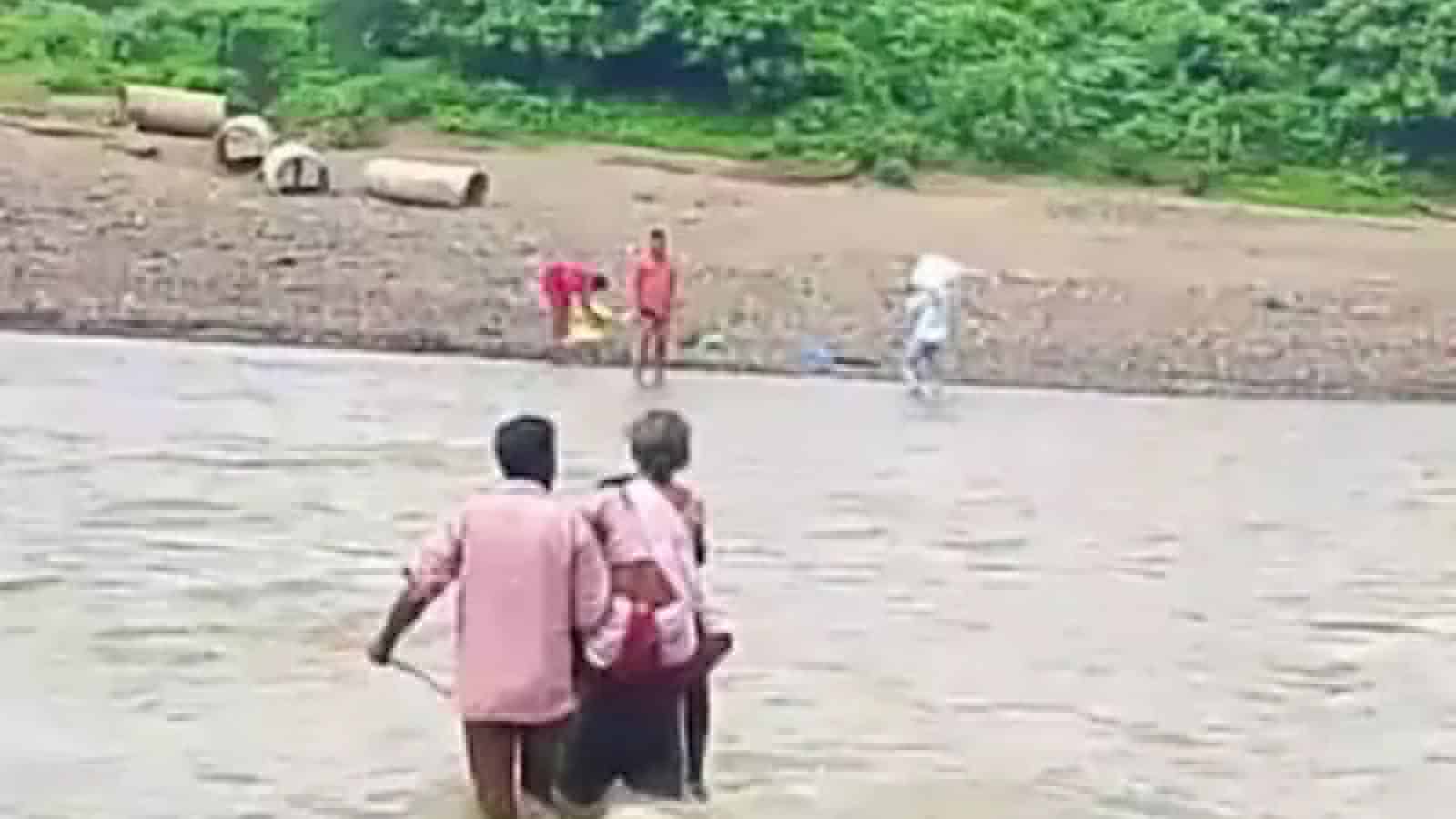 Man carries ailing mother across swollen stream in Asifabad