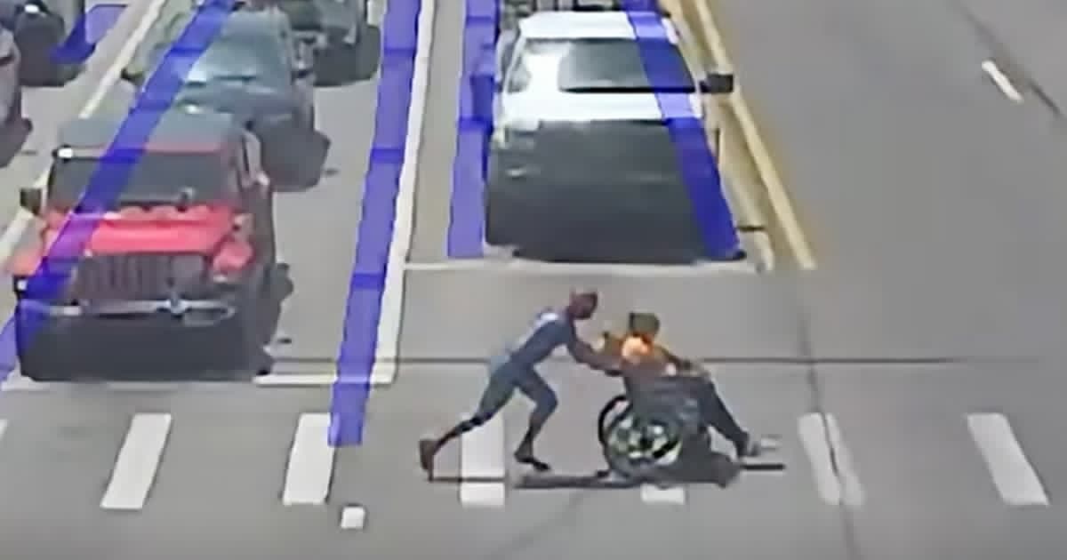 'Spider-Man' to the rescue - Helps man in wheelchair cross street