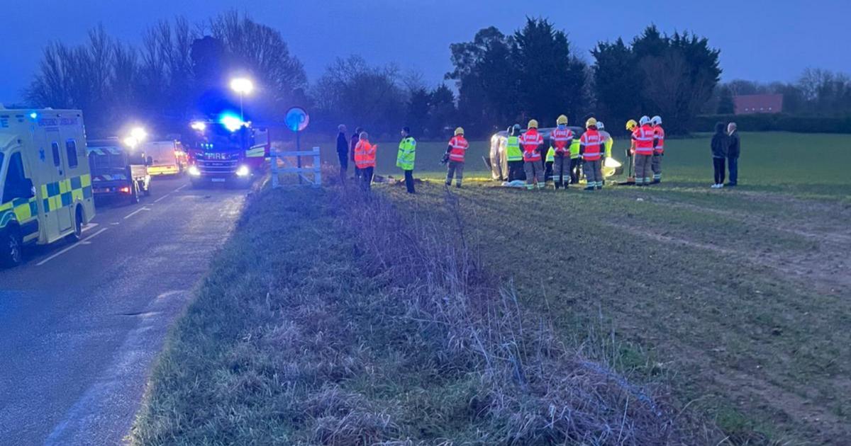 Person taken to hospital after car overturns into field
