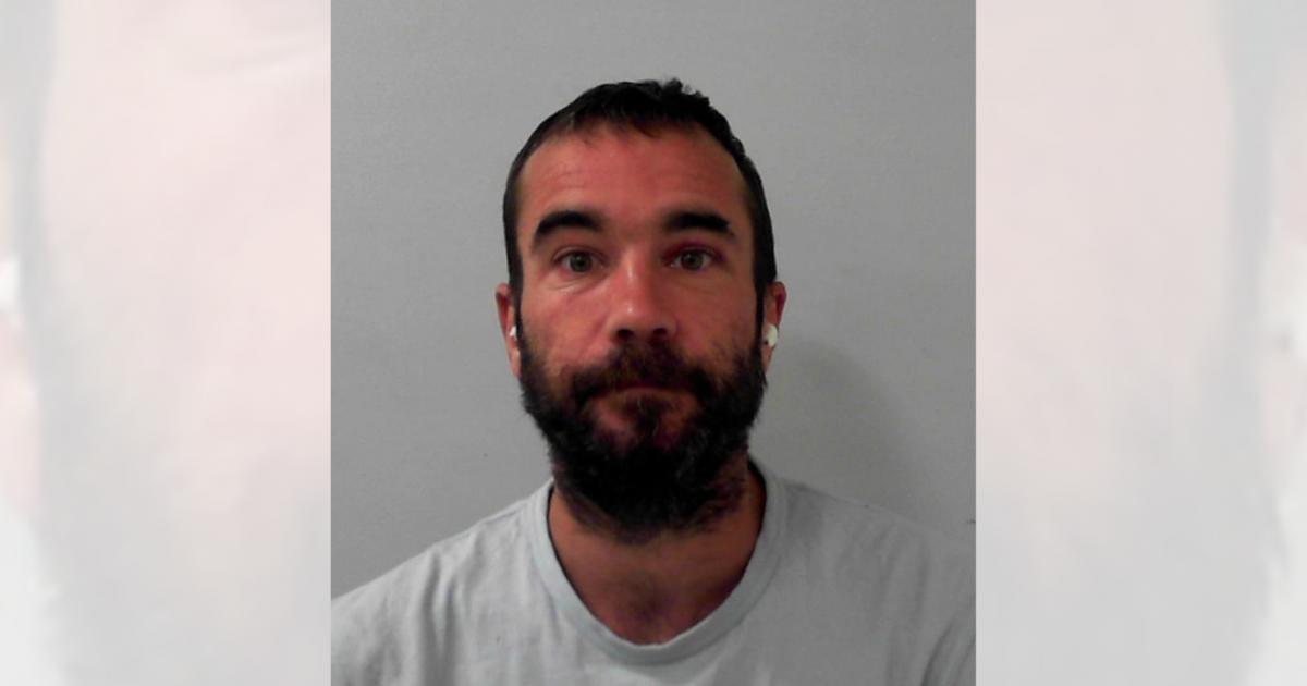 Drink-fuelled thug spat at police and made cut-throat gesture to passer-by