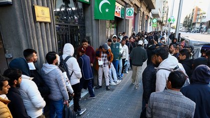 Huge crowds of male migrants gather for docs after socialist Spain offers legal status to 500,000…as Elon Musk weighs in