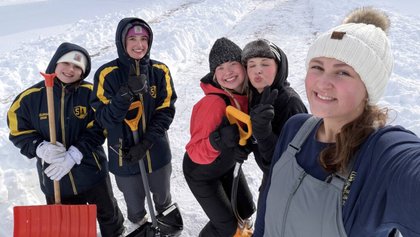 Volunteers lend a hand to help neighbors overcome the snow