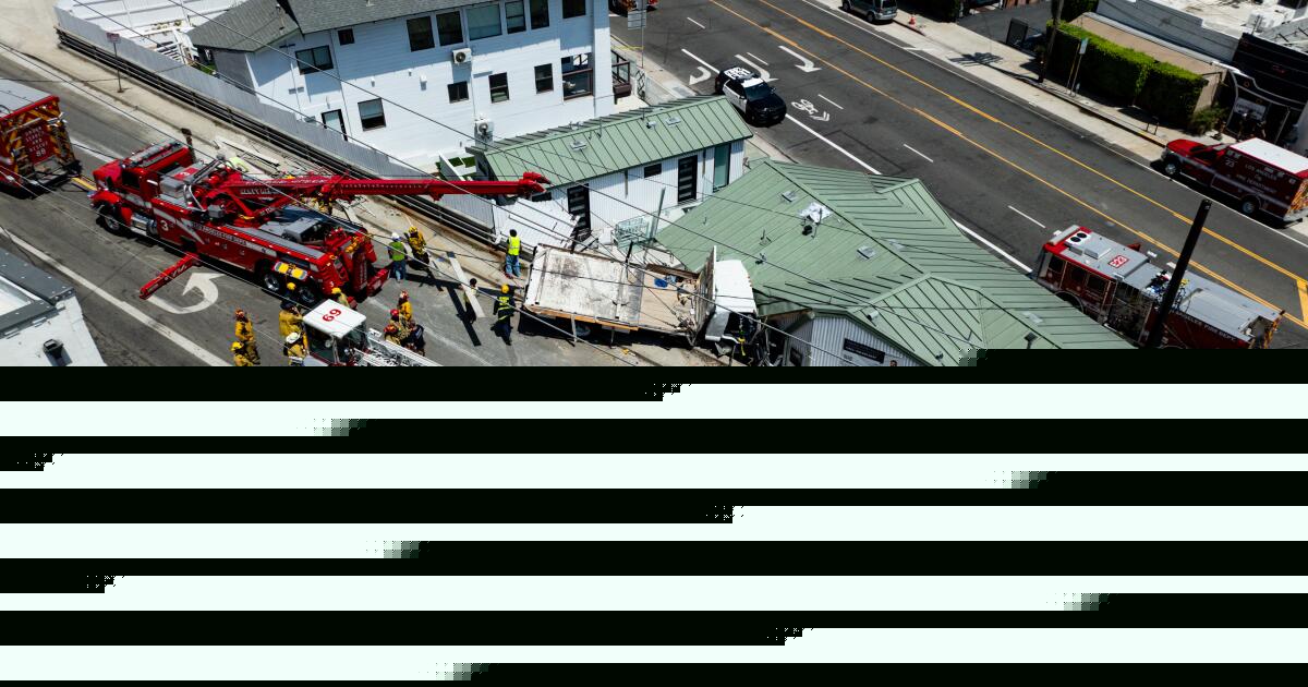 Fire crews rescue man trapped in truck that crashed into a Pacific Palisades building