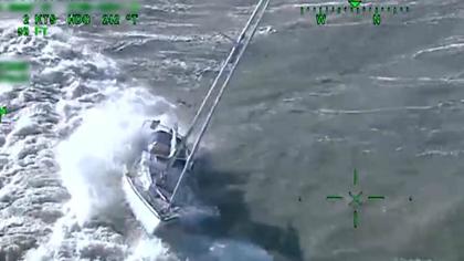 Dramatic moment coastguard attempts to save skipper's life as yacht is thrown around by powerful waves