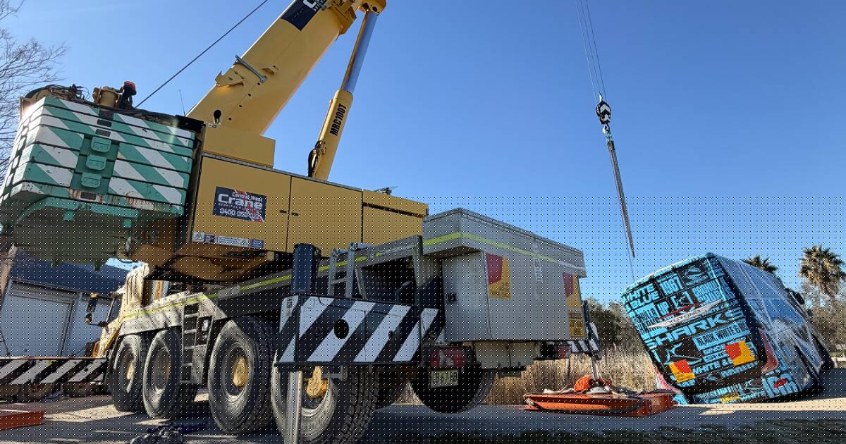 'Tricky job': Cronulla Sharks branded bus craned out of pond outside of Mudgee
