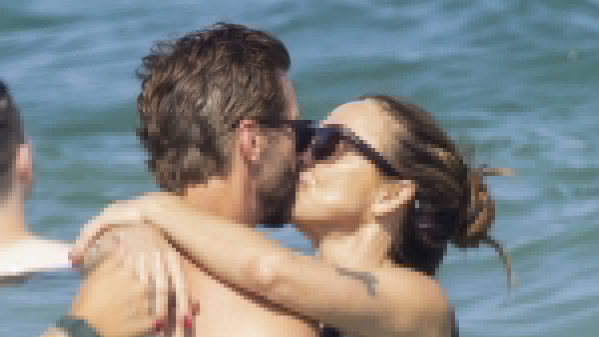 Mel C and new husband Chris Dingwall passionately kiss one another during their family honeymoon in Ibiza as she shows off her incredible gym-honed body in string bikini