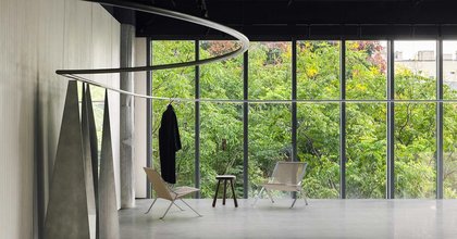 continuous steel rail traces shanghai showroom’s sculptural interior, like a freehand drawing