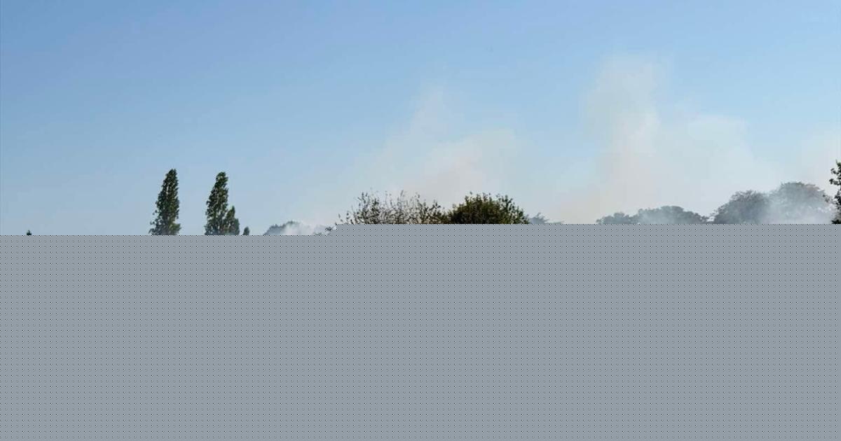 Firefighters tackling large field fire near army base