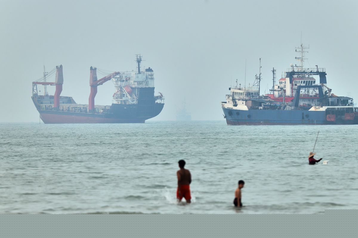 Cargo ship reports being struck in Strait of Hormuz as US, Iran claims about talks diverge