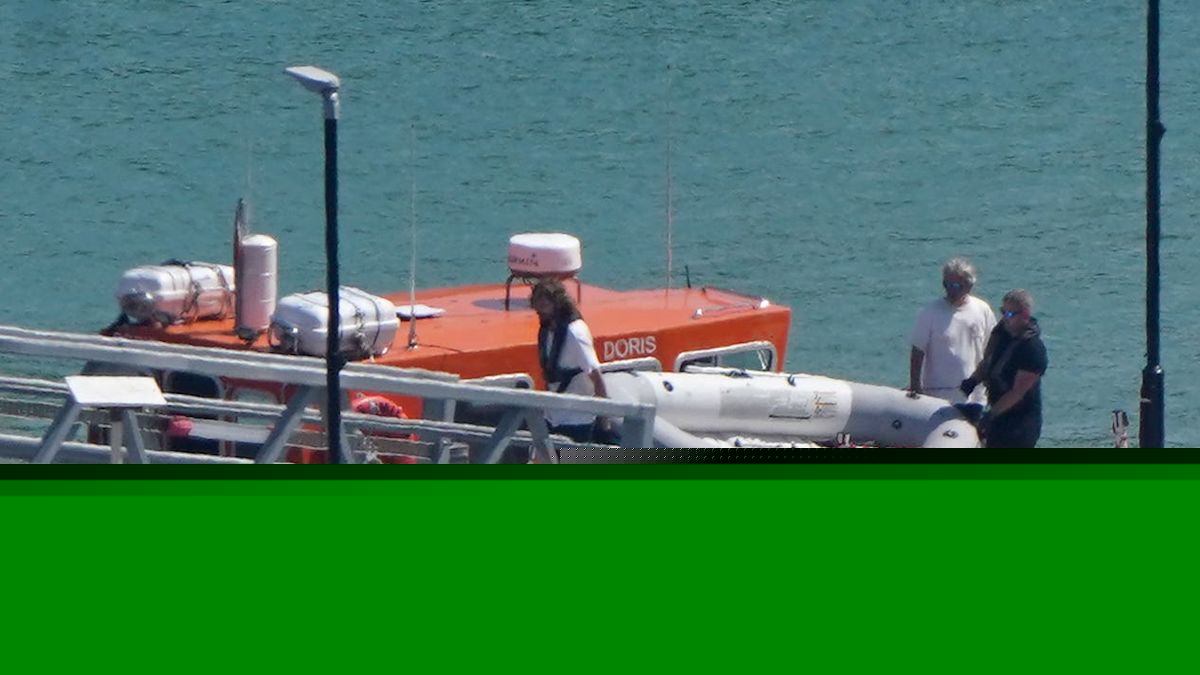 Migrants arrive after rowing tiny dinghy across the Channel